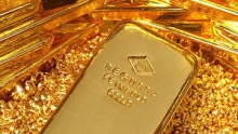 Золото подешевело в понедельник на коррекции и росте курса доллара