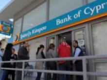 Крупные вкладчики банка Кипра потеряют около 50%